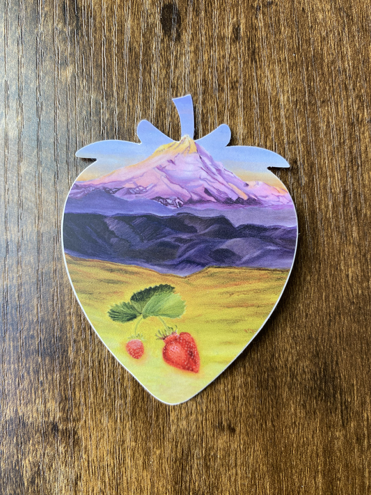 Strawberry-shaped vinyl sticker with a painted landscape of mountain Mt hood and strawberries on a wooden surface